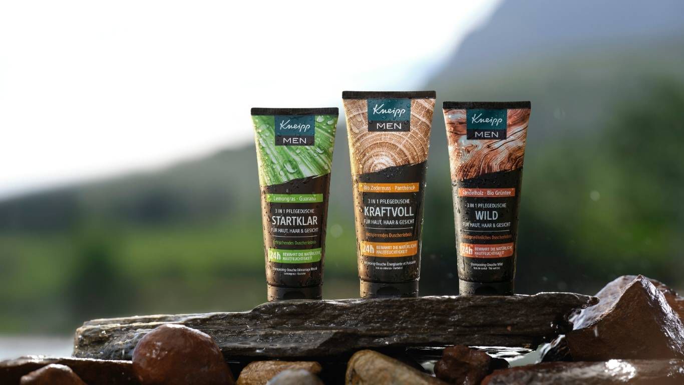 3 Kneipp MEN Duschen stehen in der Natur auf einem Stein